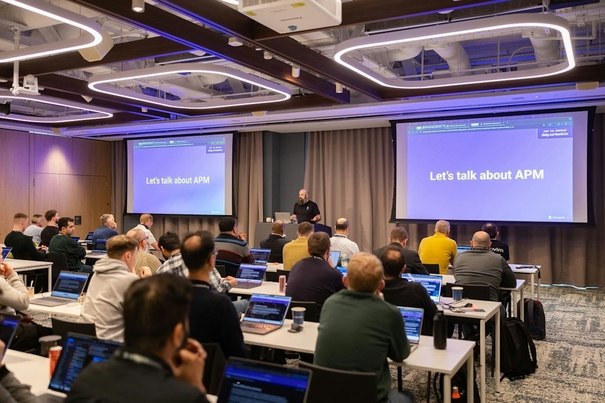 A presenter leads a workshop in a room full of attendees at Datadog Summit. A presenter leads a workshop in a room full of attendees at Datadog Summit.