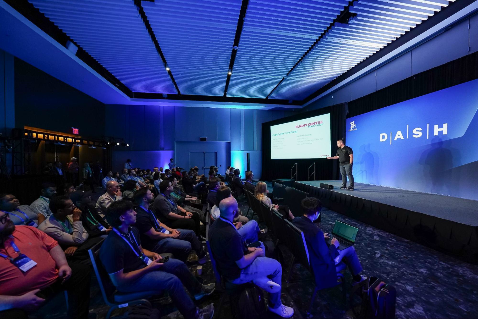 Photo of speaker presenting on stage during a breakout session at DASH 2025. Photo of speaker presenting on stage during a breakout session at DASH 2025.